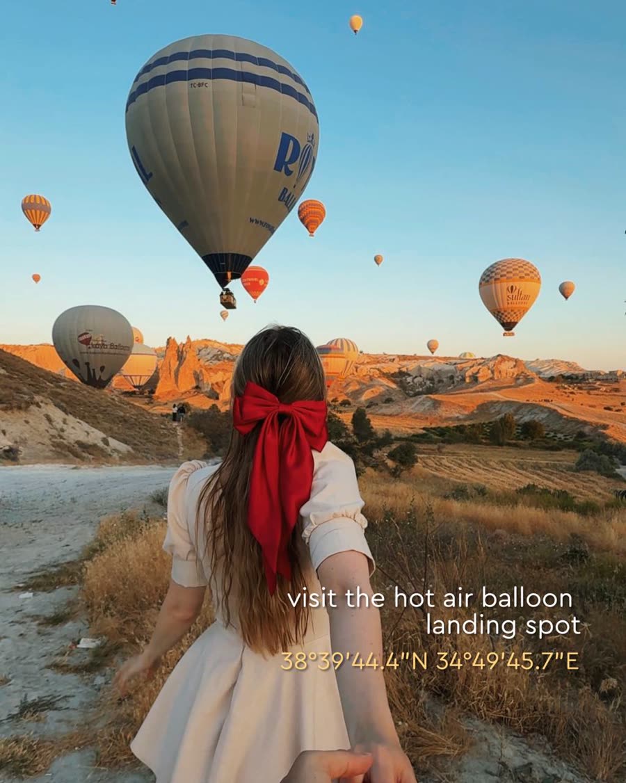 Hot air balloons coming down at the landing field at sunrise