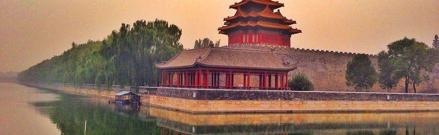 A corner tower of the Forbidden City reflected in the moat, seen from Jingshan hill