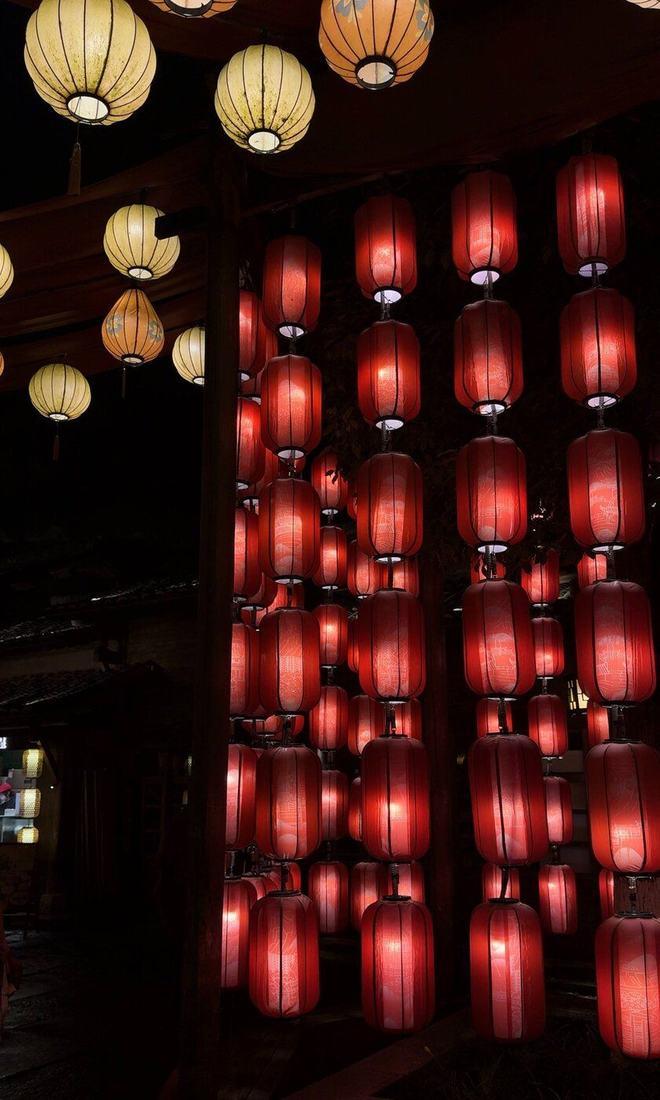 Rows of red lanterns glowing in Wangxian Valley after dark