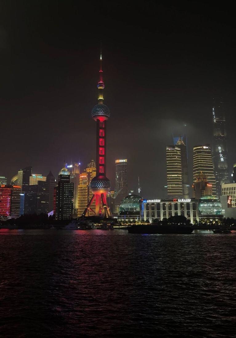 The Pudong skyline lit up across the Huangpu river at night